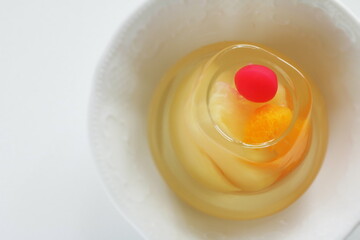 Mixed fruit Jelly in bowl on white background with copy space