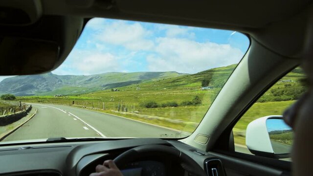 Driving through Snowdonia National park with stunning mountains, inside car view