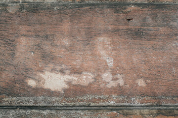 Old vintage dirty pine plank wooden floor with stains of paint.Rustic dark grunge wood texture and background.