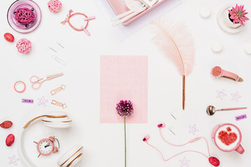 Woman desk workspace with grid paper, pink flower