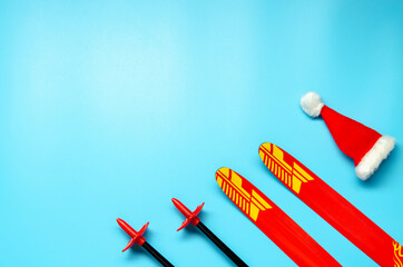 Winter sports layout with pair of skis and christmas hat. Christmas or New Year concept. Flat lay.