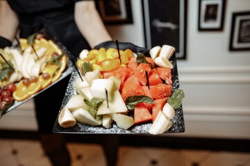 fruit platter wonderfully decorated fruits conceptual fruit platter shots in the waiter's hand luxury porcelain plate restaurant served buy