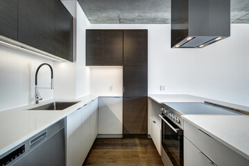 Real estate photography - Beautiful empty brand new apartment in an apartment building with bathroom, new kitchen, new floors, all white painted