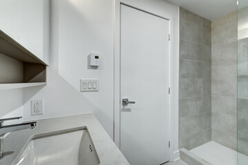 Real estate photography - Beautiful empty brand new apartment in an apartment building with bathroom, new kitchen, new floors, all white painted