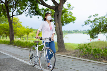 female wearing mask with bicycle