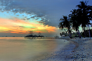 Naklejka premium sunset on the beach, lampung Sumatera Indonesia. Good for traveling brochure