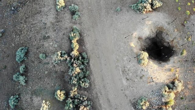 Top down view drone flying over old wooden mine head frame
