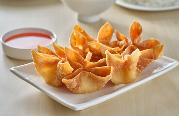 chinese crab rangoon fried wontons on plate with red sauce - obrazy, fototapety, plakaty