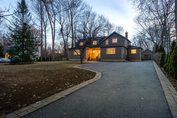 Real estate photography - exterior of single family house during twilight hours in Montreal's suburb