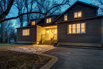 Fototapeta na wymiar Real estate photography - exterior of single family house during twilight hours in Montreal's suburb