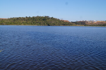 blue lake with a horizon from a forest park
