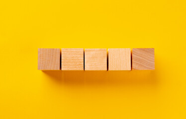 Top view of wooden cubes on yellow