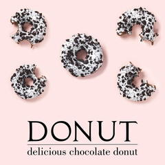creative composition of donuts on a pink background. Flat lay delicious nibbled chocolate donuts and simple text.