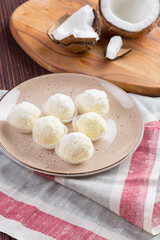 White chocolate candies with coconut topping close up