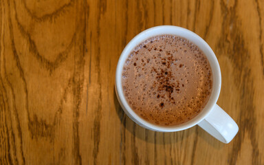 Top view of Hot cocoa on wooden table in coffee cafe. copy space for adding text