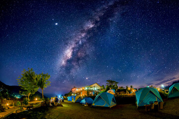 Tourist tent area on the mountain high at night in the sky with the Milky Way  Long exposure photograph, with grain.Image contain certain grain or noise and soft focus.
