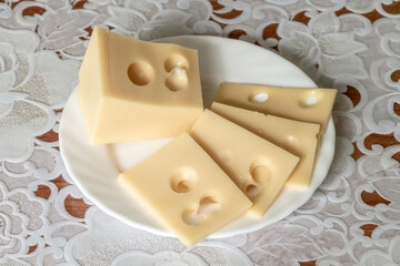 The cheese lies on a close-up of a white porcelain plate.