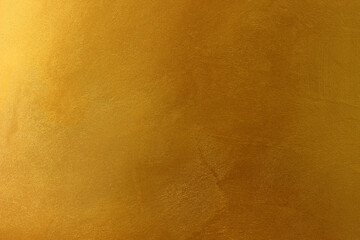 Gold or yellow paint on cement wall texture or background