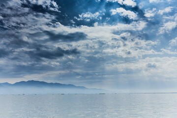 Inle Lake is in the Shan Hills of Myanmar. At its southwestern edge, Phaung Daw Oo Paya is a tiered pagoda with gilded Buddha statues. In the hills, near the market town of Indein, the stupas of Shwe 