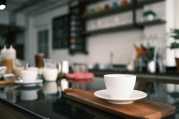 Cup of hot coffee on table in cafe