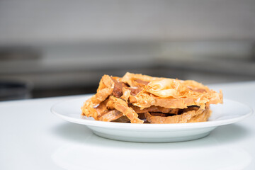 Front view of fried peking duck as served in white plate at restaurant. Chinese style 