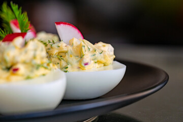 a recipe of boiled eggs filled with radish, mayonnaise, egg, onions and herbs 