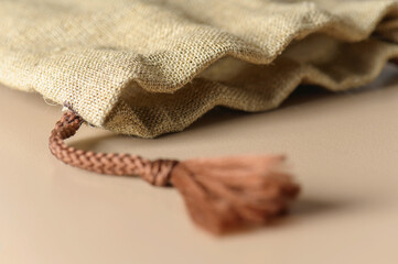 A small burlap canvas bag with rope ties. Rustic style for a gift.