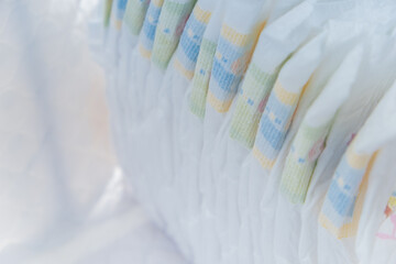 Fototapeta na wymiar Stack of newborn baby diapers on white background. Copy space