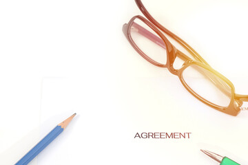 Sign on contract document with fountain pen and glasses