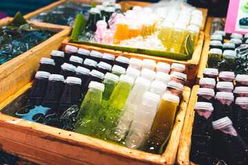 Homemade juices in bottles are sold on the market.