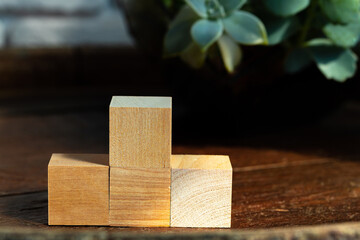 Groupped wooden square blocks on dark wooden table
