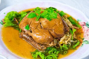 Stewed duck in white plate on table at the restaurant. Chinese cuisine style
