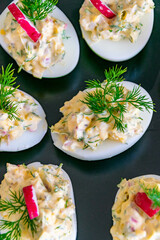 a portrait birds eye view of some freshly made stuffed boiled eggs on a plate 
