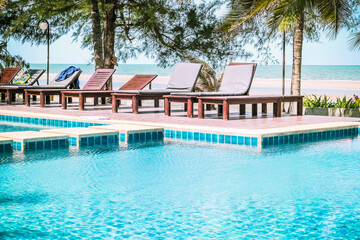 Swimming pool in a peaceful hotel on the beautiful beach by the sea at Thailand.
