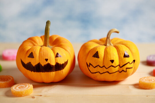 Halloween pumpkins with painted face on blue color background