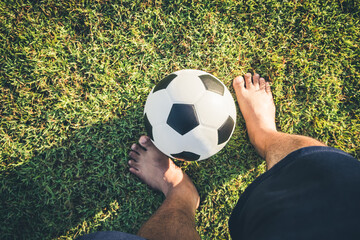 Above view of foot man playing classic leather soccer ball on grass field in the arena stadium....