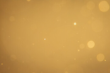 Dark Abstract Gold bokeh sparkle on black background