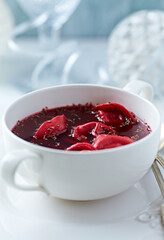 Traditional Christmas Borscht (Barszcz) with mushroom dumplings on bright background.	