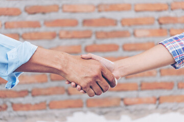 Civil Construction engineer teams shaking hands together wear work helmets worker on construction...