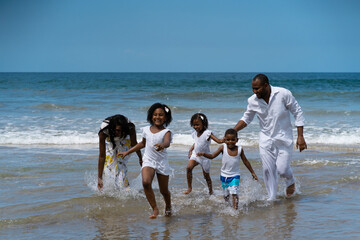 dads and children playing on the beach © Eduardo