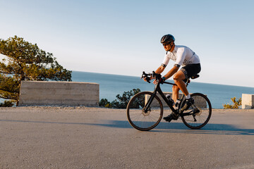 Cycling sport athlete man riding on coastal road