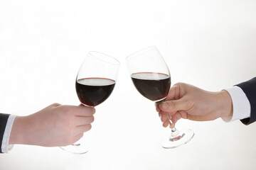businessman and businesswoman toasting with wine on white background
