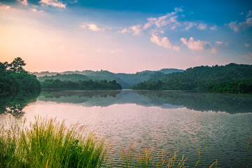 Cozy outdoor reservoir with terrace big mountain at sunset in the morning, Thailand. The atmosphere of the pool and the nature on the quiet hill. Dam with landscape background.