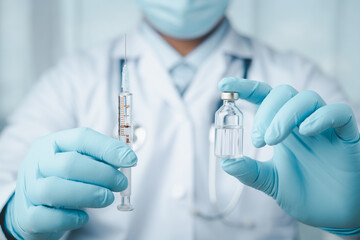 vaccines fight against virus covid-19 corona virus, doctor or scientist in laboratory holding a syringe with liquid vaccines for children or older adults,Concept:diseases,medical care,science.