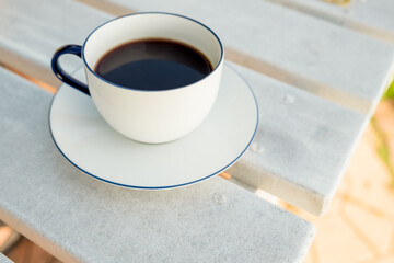 Coffee cup and saucer on wooden table in cafe. Top view. Espresso delight