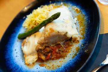 Cod fillet on vegetable ratatouille with chorizo, gratin with honey and rosemary aioli