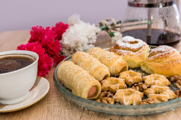 many tasty sausage in bread rolls and cup of coffee for breakfast