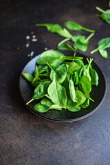 spinach salad green juicy leaves organic salad serving size natural top view copy space  for text diet raw food background rustic