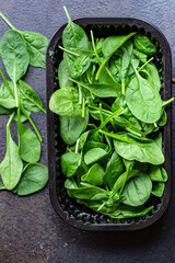 spinach salad green juicy leaves organic salad serving size natural top view copy space  for text diet raw food background rustic