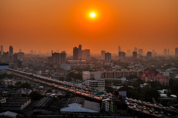 Fototapeta premium Aerial view of the modern buildings and skyscrapers at sunset of Bangkok City, Thailand.